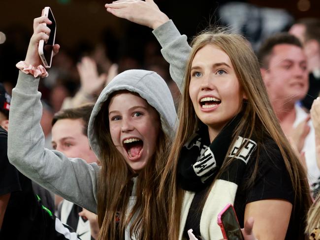 MELBOURNE, AUSTRALIA - MARCH 17: Collingwood fans celebrate a goal during the 2023 AFL Round 01 match between the Geelong Cats and the Collingwood Magpies at the Melbourne Cricket Ground on March 17, 2023 in Melbourne, Australia. (Photo by Dylan Burns/AFL Photos via Getty Images)