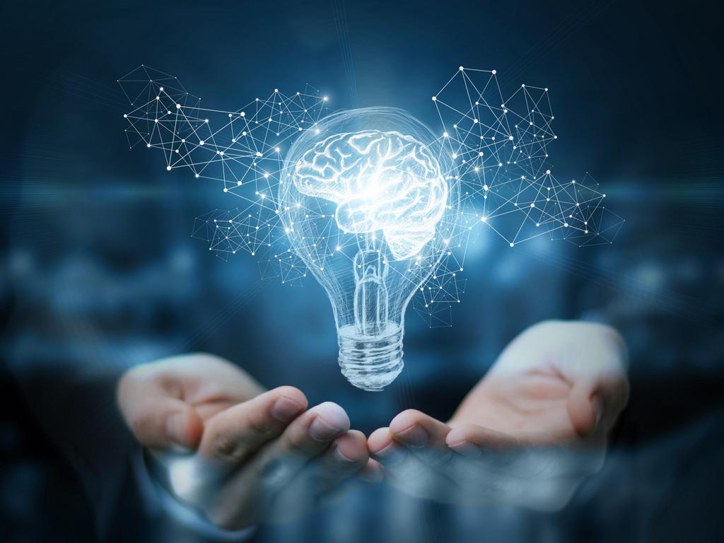 Light bulb with brain inside the hands of the businessman. The concept of the business idea.