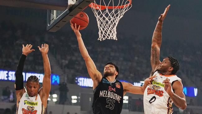 Shea Ili scores after driving past Cameron Oliver of the Taipans. Picture: AAP