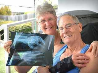 OUCH: Gail comforts husband Ralph Kark who sliced his hand open on a ceiling fan at his Southside home this week. Picture: Renee Albrecht