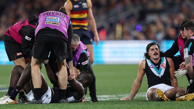 Aliir Aliir and Lachie Jones after their big clash on Saturday night. Picture: Sarah Reed/AFL Photos via Getty Images