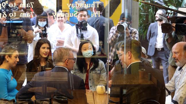 Anthony Albanese with Labor candidate Jerome Laxale and constituents at a Sydney cafe hours before announcing he has Covid. Picture: Toby Zerna