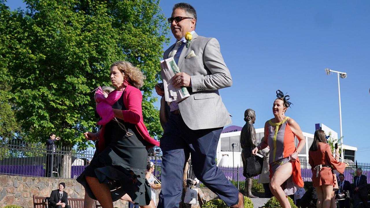 Racegoers run to get a good position. Picture: AAP