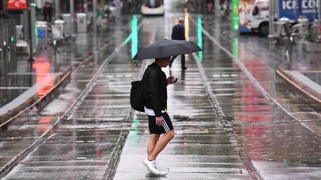 A sodden Bourke Street in Melbourne's CBD. Picture: AAP Image/James Ross.