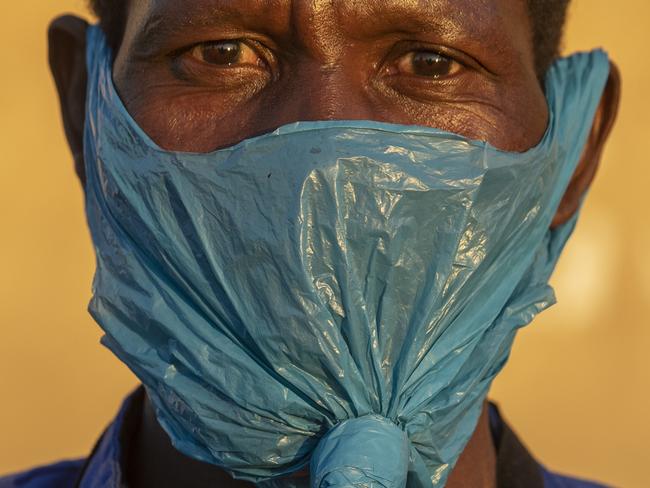 A man wears a plastic bag on his face as a precaution against the spread of coronavirus in Johannesburg, South Africa. Picture: AP Photo/Themba Hadebe