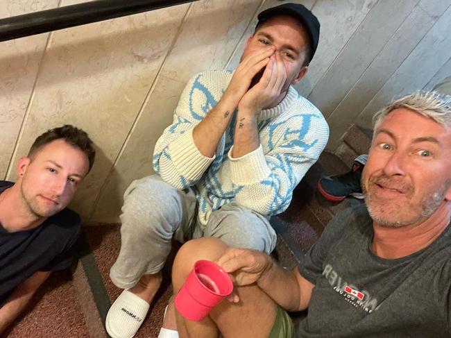 Hugh Sheridan (centre) shelters with friends including David Draper (right) in an Israeli hotel stairwell. Picture: Instagram/David Anthony Draper