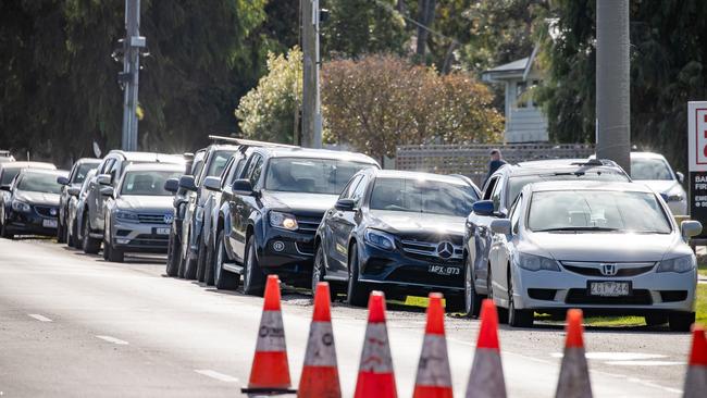 People lining up to be tested at Barwon Heads where a primary school and footy club were visited by a positive case. Picture: Jason Edwards