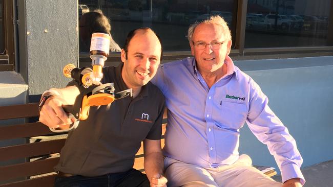 Director and developer of Numnuts Robin Smith with the device and his father David Smith, the inventor of Barbervax.