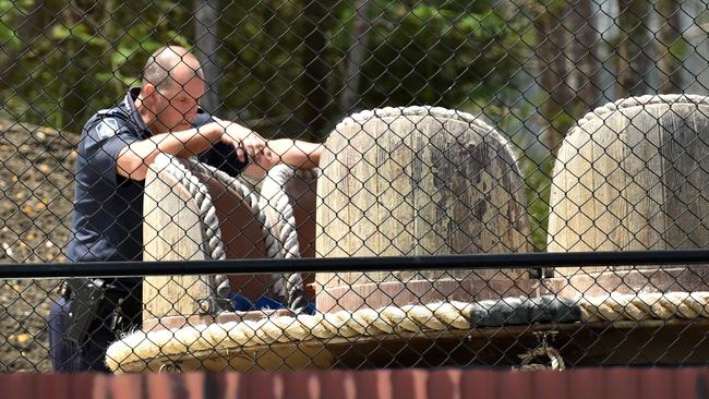 A police officer takes a look at a raft that is used by the Thunder River Rapid ride. Picture: Nigel Hallett