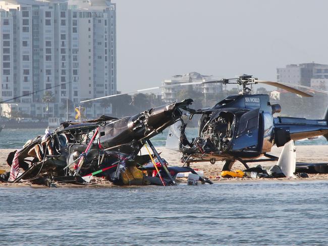 The devastating wreckage of two Sea World Helicopters which collided mid-air just outside the tourist park on a sandbank. Picture: Glenn Hampson