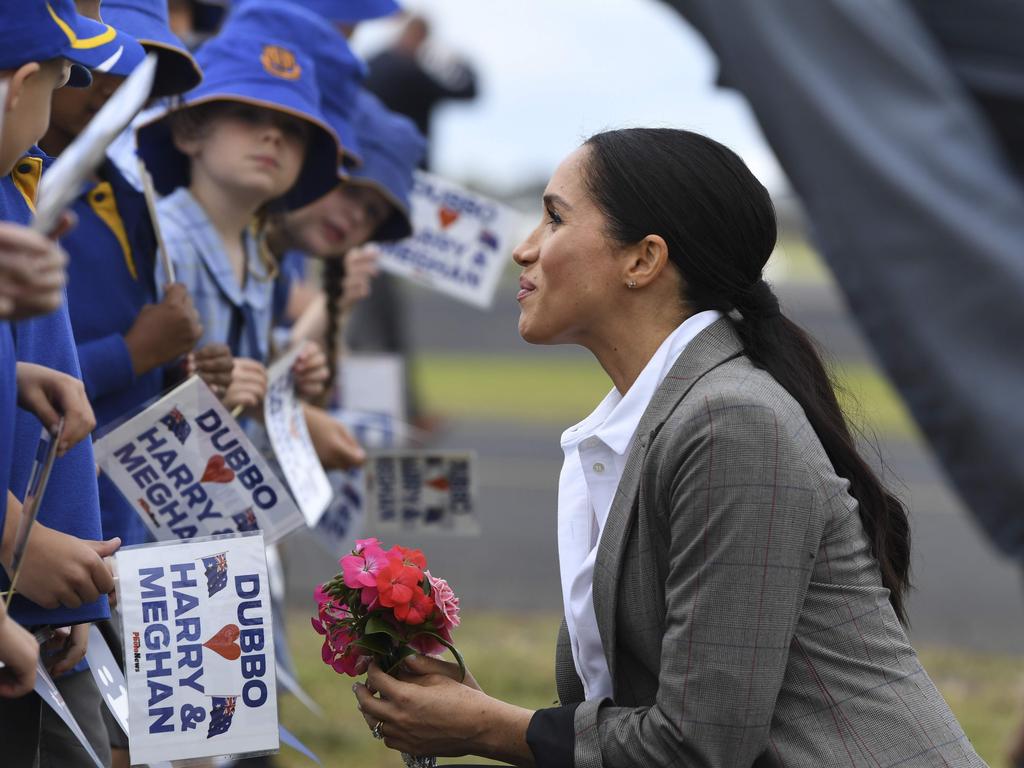 Meghan was all smiles as they met schoolkids in Dubbo. Picture: Dean Lewins/AFP