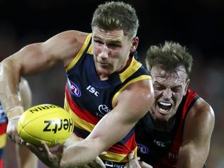 AFL - Adelaide Crows v Essendon - Round 4  - Adelaide Oval. Rory Laird gets his handpass away from the Brendon Goddard tackle.  Picture Sarah Reed