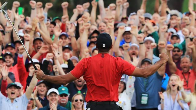 GETTY IMAGES - 2019 Sport Year In Focus - AUGUSTA, GEORGIA - APRIL 14: Patrons cheer as Tiger Woods of the United States celebrates after sinking his putt on the 18th green to win during the final round of the Masters at Augusta National Golf Club on April 14, 2019 in Augusta, Georgia. (Photo by David Cannon/Getty Images)