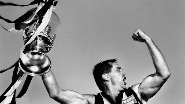 1990: Collingwood breaks a 32-year drought to win the 1990 premiership cup, held aloft by captain Tony Shaw. And relegating the Colliwobbles to a distant memory. Picture: Mike Keating