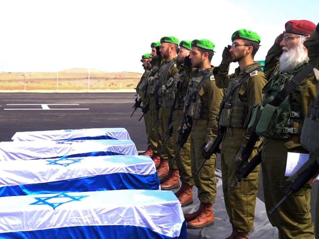 In an image released on February 20, 2025, Israeli soldiers carry the coffins of deceased hostages Oded Lifschitz, Shiri Bibas and her two children Kfir and Ariel Bibas, who were kidnapped during the deadly October 7, 2023 attack by Hamas, and were handed over under the terms of a ceasefire between Hamas and Israel, in the Gaza Strip. Picture: Government Press Office / GPO