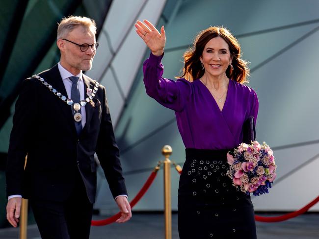 Denmark’s Queen Mary waves after she leaves Aalborg University’s 50th anniversary celebrations with university rector Per Michael Johansen on Saturday. Picture: AFP