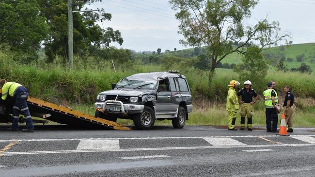 Two people were when a car rolled on the Bruce Highway near Bells Bridge on Friday morning, causing highway traffic delays.