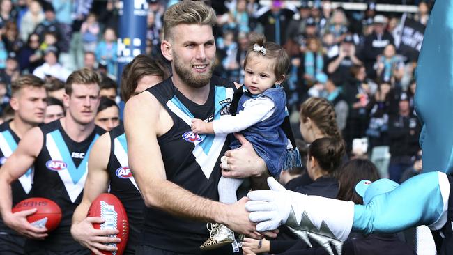 Jackson Trengove with Sophia before his 150th game. Picture Sarah Reed