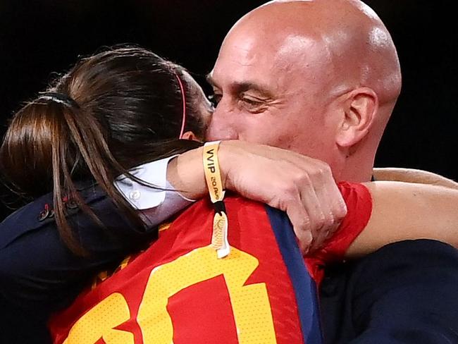 Spain's defender #20 Rocio Galvez is congratuled by President of the Royal Spanish Football Federation Luis Rubiales (R) next to Spain's Jennifer Hermoso after winning the Australia and New Zealand 2023 Women's World Cup final football match between Spain and England at Stadium Australia in Sydney on August 20, 2023. The Spanish football federation (RFEF) on August 26, 2023 threatened to take legal action over Women's World Cup player Jenni Hermoso's "lies" about her kiss with its president Luis Rubiales. (Photo by FRANCK FIFE / AFP)