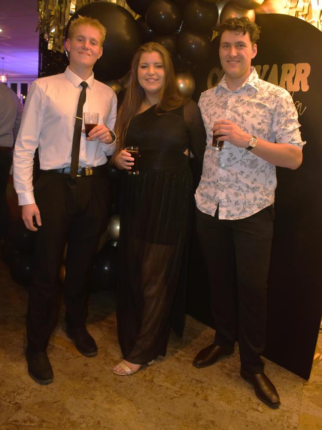 Hamish Zee-Verner, Tara Whelan and Simon Lea having a great night at the Cowwarr Saints Football &amp; Netball Club Golden Gala Ball 2024. Picture: Jack Colantuono