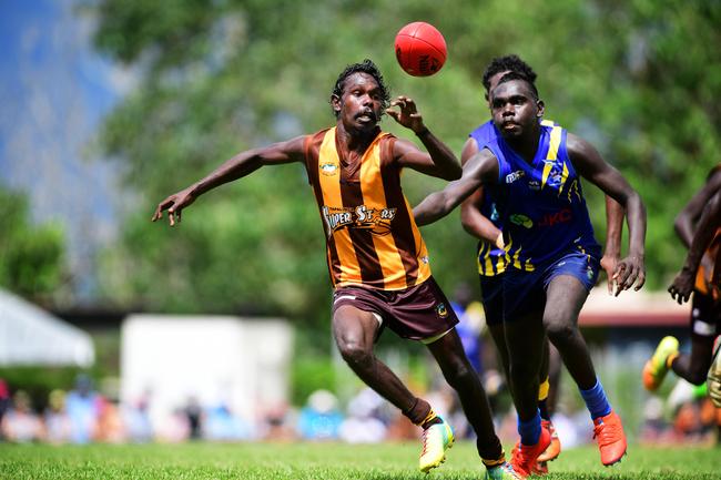 Ranku Eagles Timothy Babui chases down Tapalinga Superstars Gene Puruntatameri during this year's 49th Annual Tiwi Grand Final at Wurrumyanga Oval on Bathurst Island Picture: Justin Kennedy Picture: Justin Kennedy