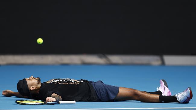 In a rare moment of reflection, Nick Kyrgios laid down at Melbourne Park after an intense practice session ahead of the 2023 Australian Open. Picture: Getty Images.