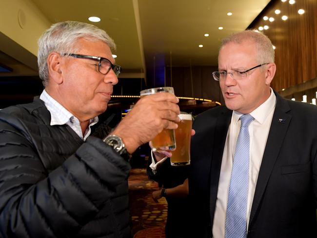 Scott Morrison toasts former PM Bob Hawke with Warren Mundine during a visit to the Bombaderry Mens Bowling Club. Picture: Tracey Nearmy/Getty