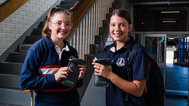 Port Lincoln High School students Sophie Lang (left) and Caitlin Cole with the lockable pouches containing their phones. Picture: Robert Lang