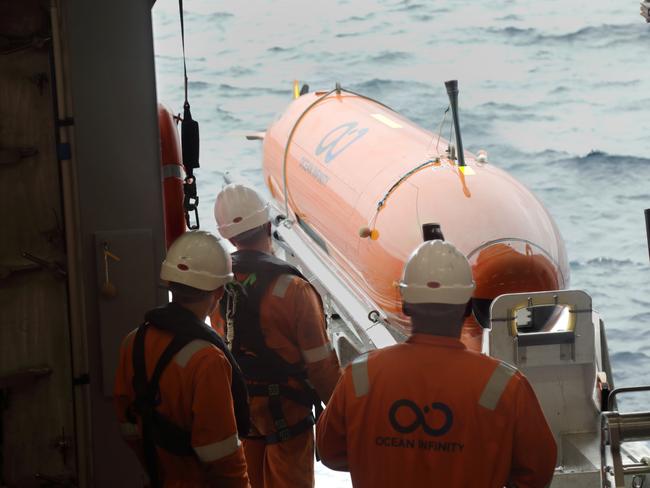 (FILES) This undated handout file photo released to AFP on January 24, 2018 by Ocean Infinity shows an autonomous underwater vehicle (AUV), one of eight used for the hunt of Malaysia Airlines' flight MH370 that went missing in 2014, being deployed at sea. The disappearance of the Boeing 777 carrying 239 passengers and crew almost four years ago is one of aviation's greatest mysteries, with an Australian-led hunt across a 120,000 square-kilometre (46,000 square-mile) zone failing to reveal the crash site.  / AFP PHOTO / OCEAN INFINITY / HANDOUT / TO GO WITH Australia-Malaysia-China-aviation-MH370,FOCUS by Glenda Kwek -----EDITORS NOTE --- RESTRICTED TO EDITORIAL USE - MANDATORY CREDIT "AFP PHOTO / Ocean Infinity" - NO MARKETING - NO ADVERTISING CAMPAIGNS - DISTRIBUTED AS A SERVICE TO CLIENTS - NO ARCHIVES /