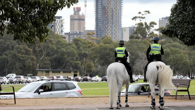 Police watch cars in the kilometres-long queue for Covid tests at Victoria Park Tuesday. Picture Dean Martin