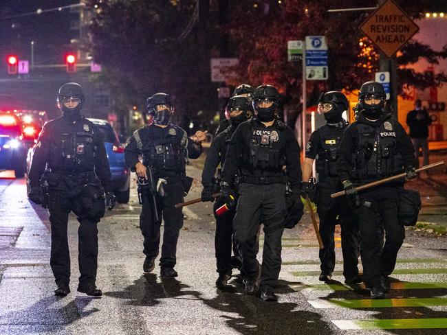 Police follow protesters as they move through the city during racial justice protests in Seattle, Washington. Picture: AFP