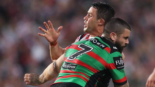 Rabbitohs halfback Adam Reynolds crunches Cooper Cronk. Picture: Phil Hillyard