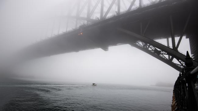 Heavy fog shrouds the Harbour Bridge this morning. Picture: Monique Harmer