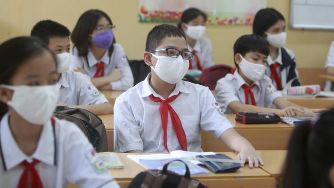 Students wearing masks attend a class in Dinh Cong secondary school in Hanoi, Vietnam. Picture: AP Photo/Hau Dinh