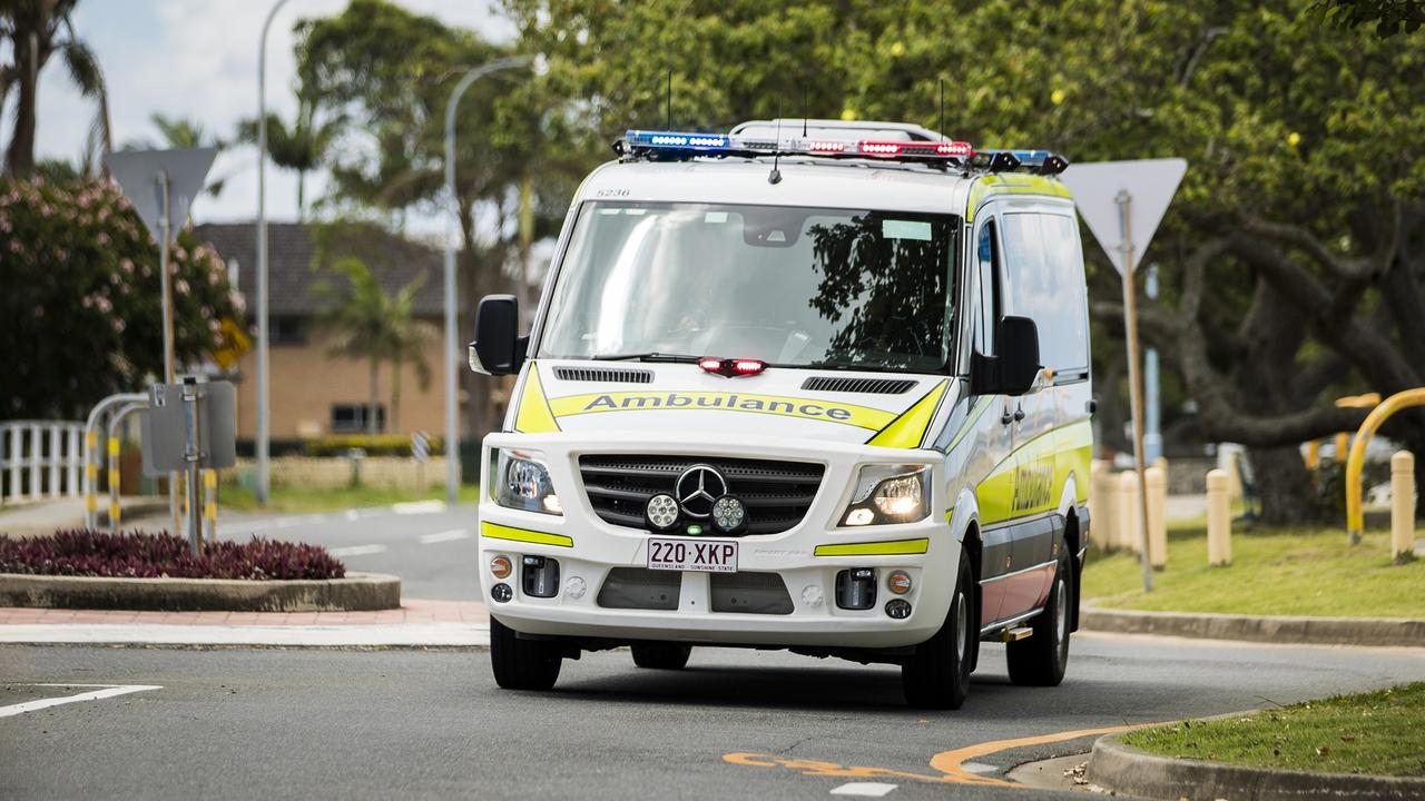 Paramedics treat a young girl in Glenvale after a traffic crash. 