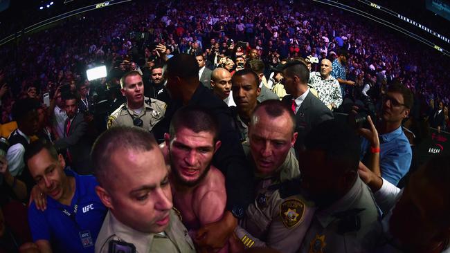 Khabib was escorted out. Photo: Harry How/Getty Images/AFP