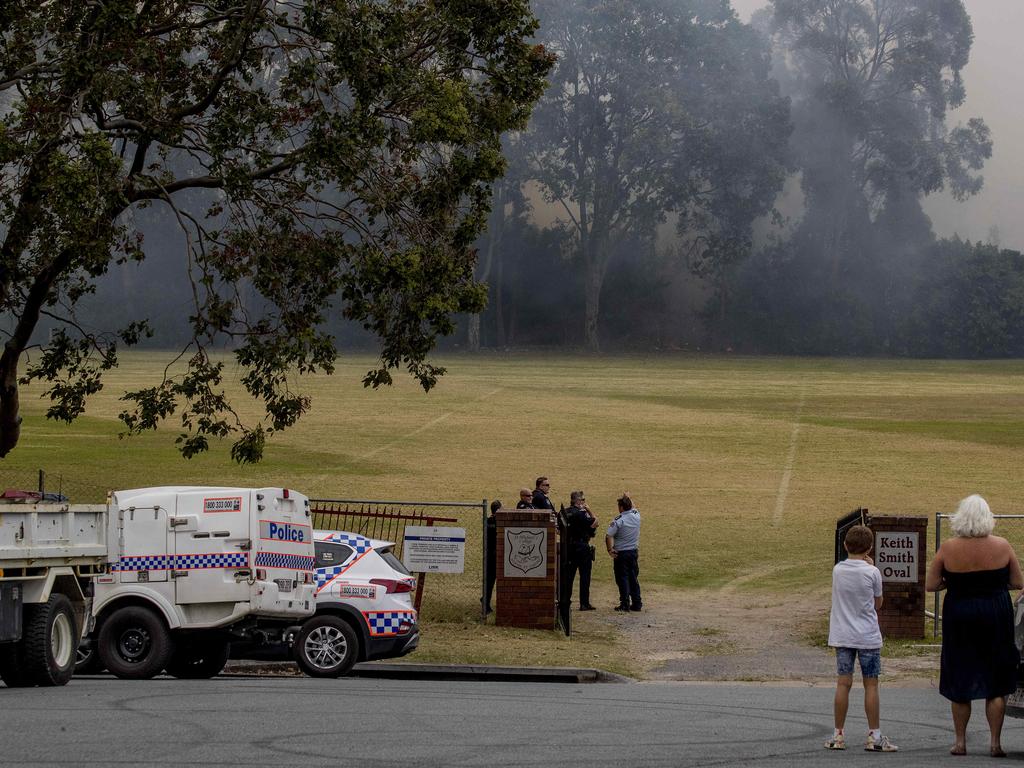 Smoke haze covers the Gold Coast Skyline from a grass fire at Carrara. Emergency services at St Michael's Collage, Merrimac. Fire burning near the school oval. Picture: Jerad Williams