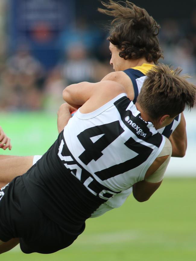 Tobin Cox lays a tackle on Adelaide's Will Hamill. Picture: RUSSELL MILLARD/AAP