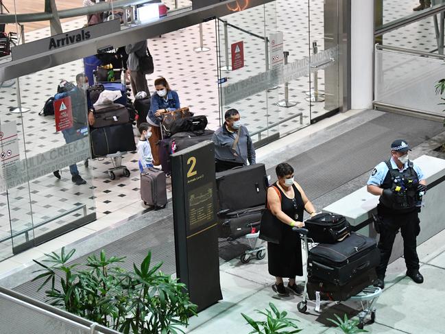 Australians evacuated from South America due to the coronavirus (COVID-19) are seen after landing at Brisbane International Airport in Brisbane, Tuesday, April 14, 2020. The Qantas flight from Lima, repatriated 115 passengers back to Australia. (AAP Image/Darren England) NO ARCHIVING