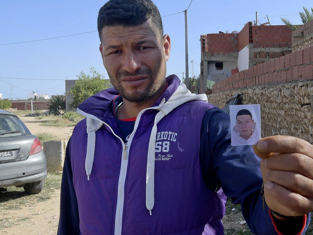 Yassin holds up a photo of his brother, accused Nice assailant Brahim Aouissaoui. Picture: Fethi Belaid/AFP