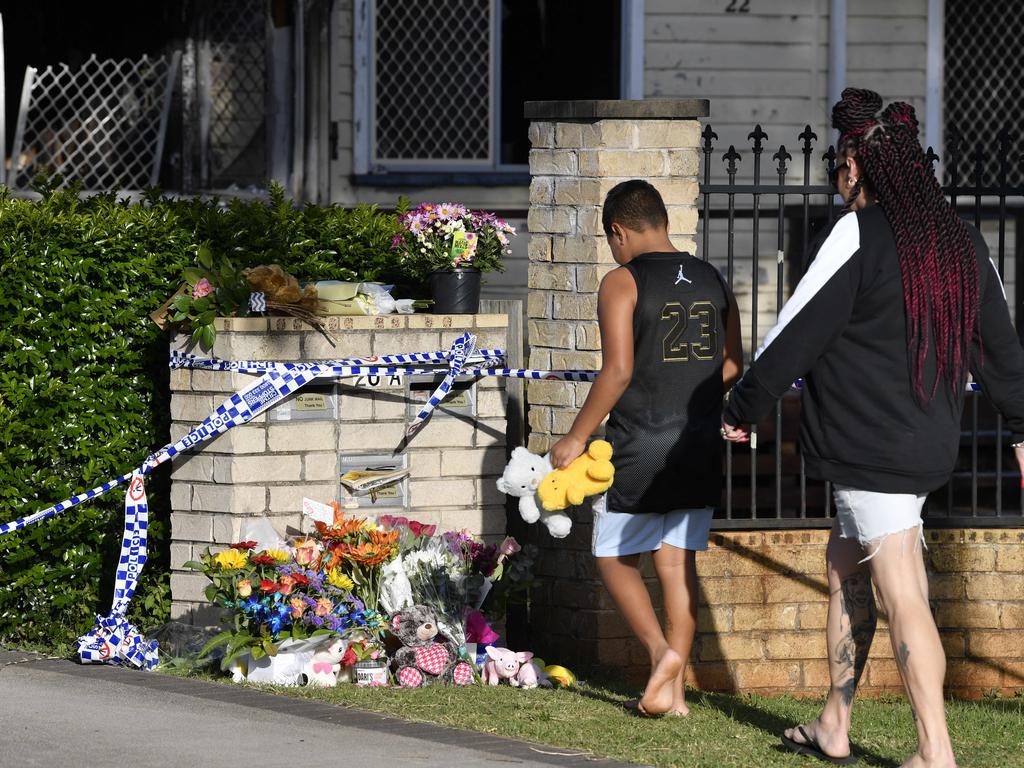 Flowers and soft toys left near the scene. Picture: Kevin Farmer