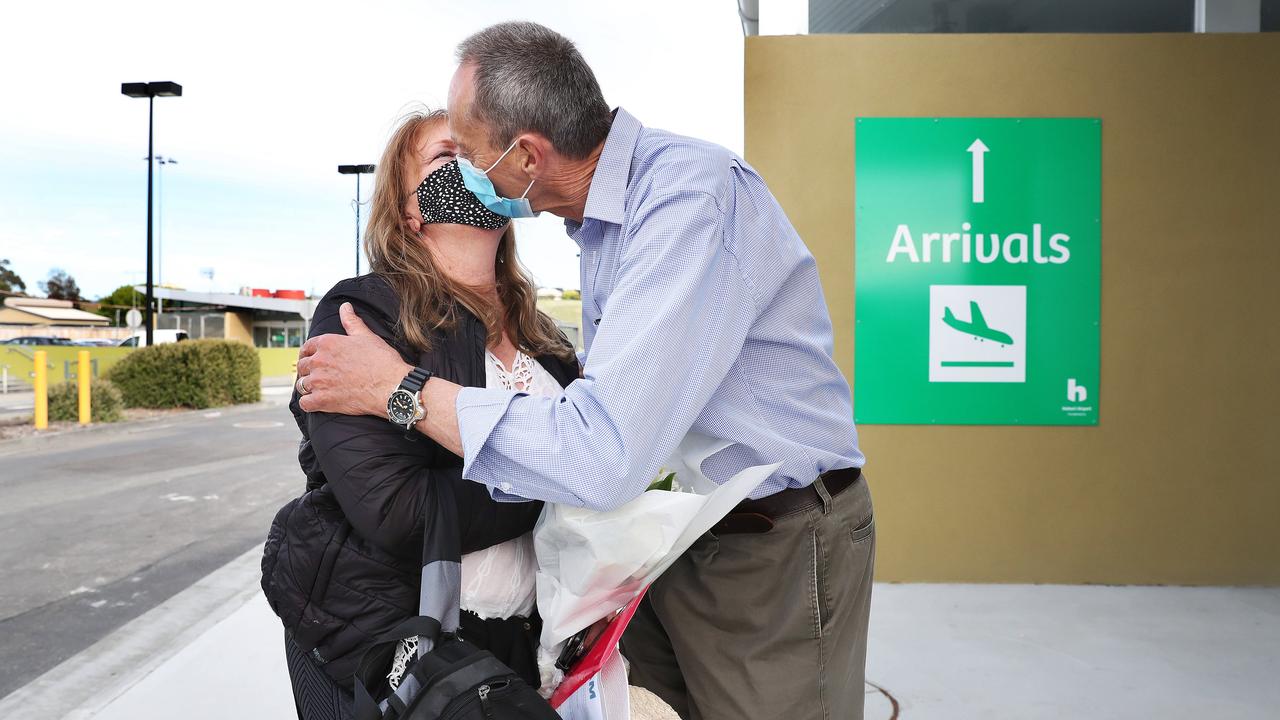 Colin Lester hugging wife Mairi Lester who arrived home. Tasmanian borders open to high risk states once again. Picture: Nikki Davis-Jones