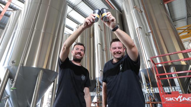 Black Hops Brewery has been so successful they've opened a second location in Biggera Waters. Owners Dan Norris and Michael McGovern toast future success at the plant. Picture Glenn Hampson