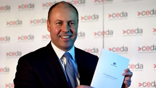 Treasurer Josh Frydenberg holds a copy of the 2021 Intergenerational Report this week. Its projections assume that China will continue to play fiscal Santa Claus every year for 40 years. Picture: AFP