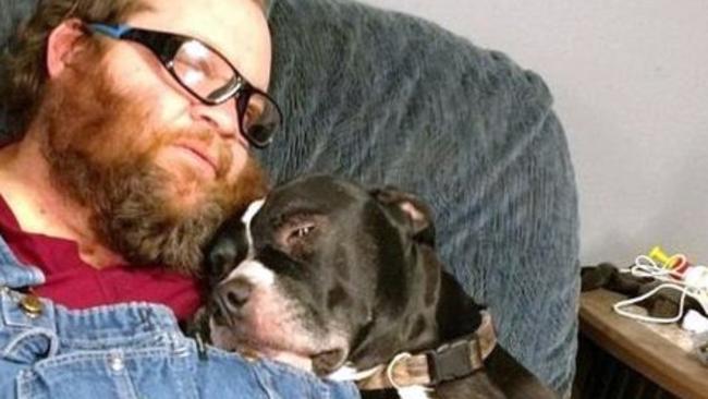 Still a good boy. Richard Remne and his beloved dog Balew snuggle on the lounge. Picture: Twitter