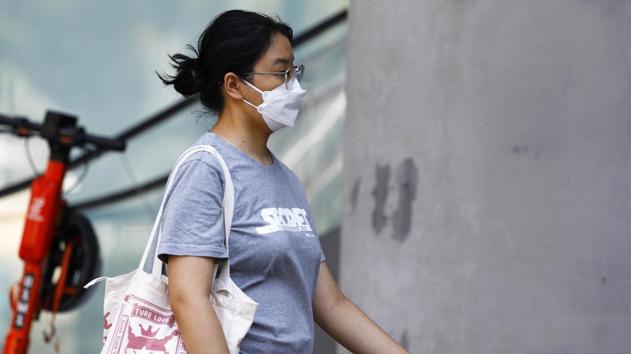 A woman is seen wearing a mask in Brisbane.