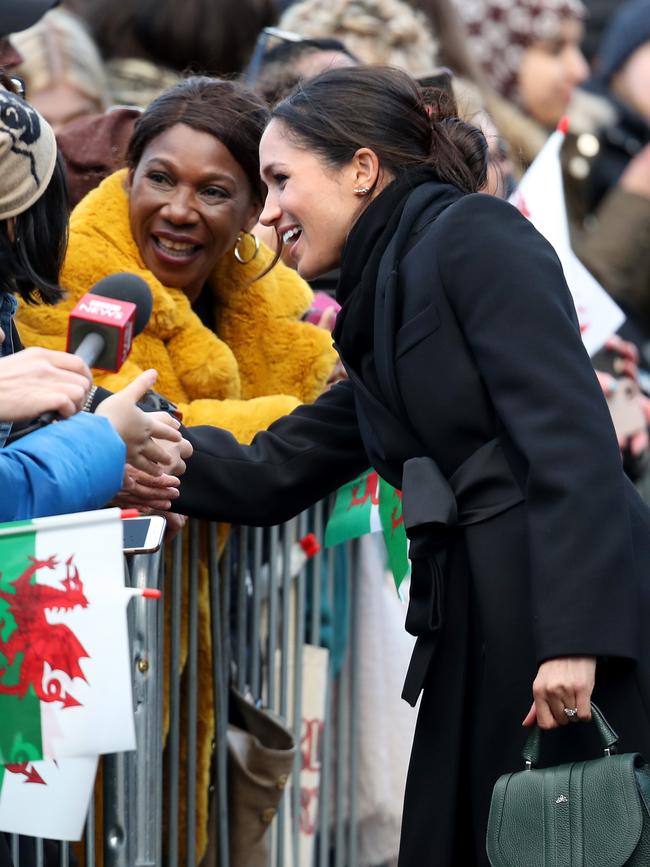 Meghan Markle talks to a member of the public as she arrives to a walkabout at Cardiff Castle on January 18, 2018 in Cardiff, Wales. Picture: Getty