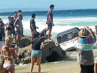 INUNDATED. A vehicle comes to grief on the Mudlo Rocks at Rainbow Beach. Picture: Contributed