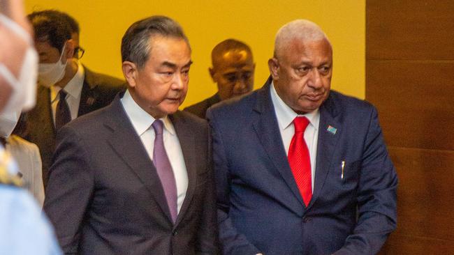 Chinese Foreign Minister Wang Yi and then Fijian Prime Minister Frank Bainimarama. Picture: Leon Lord/AFP