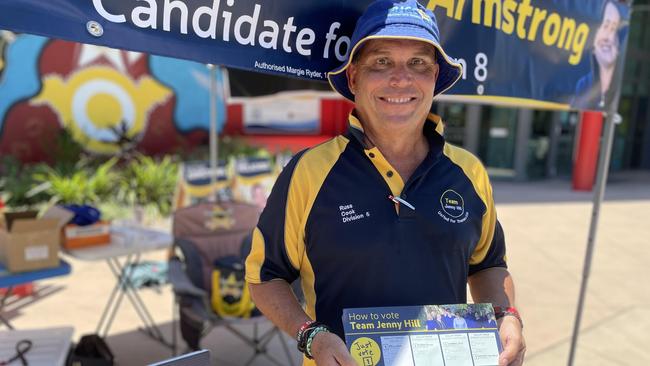 Division 5 candidate Russ Cook hands out how-to-vote cards at the pre-poll booth at Aitkenvale.